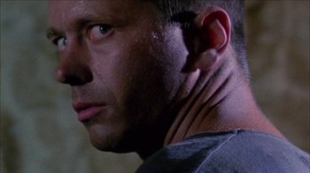 Movie still from “Poison” (1991), directed by Todd Haynes – A man's face and neck; Close Up shot, Low angle