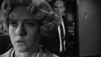 Movie still from “Poison” (1991), directed by Todd Haynes – A man and a woman in a black and white photo; Close Up shot, Over the shoulder angle
