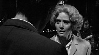 Movie still from “Poison” (1991), directed by Todd Haynes – An old photo of a woman talking to a man; Close Up shot, Over the shoulder angle