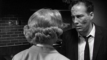 Movie still from “Poison” (1991), directed by Todd Haynes – A man and a woman are talking to each other; Close Up shot, Over the shoulder angle