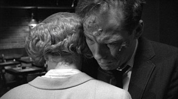 Movie still from “Poison” (1991), directed by Todd Haynes – An older man and a younger woman embracing each other; Close Up shot, Low angle