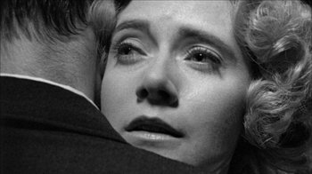 Movie still from “Poison” (1991), directed by Todd Haynes – A person laying on the ground; Close Up shot, Over the shoulder angle