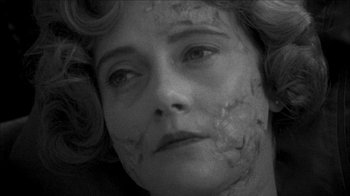 Movie still from “Poison” (1991), directed by Todd Haynes – A black and white photo of a woman's face; Close Up shot, High angle