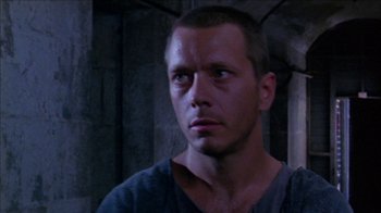 Movie still from “Poison” (1991), directed by Todd Haynes – A person looking at the camera; Close Up shot, Low angle