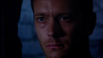 Movie still from “Poison” (1991), directed by Todd Haynes – A man's face in the dark; Close Up shot, Low angle