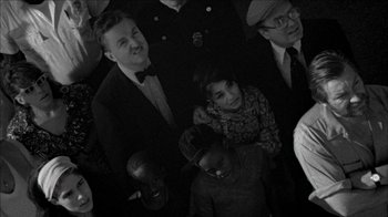 Movie still from “Poison” (1991), directed by Todd Haynes – A black and white photo of a group of people; Medium shot, High angle