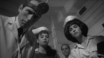 Movie still from “Poison” (1991), directed by Todd Haynes – A black and white photo of a group of people wearing hats; Medium shot, Low angle