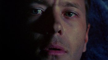 Movie still from “Poison” (1991), directed by Todd Haynes – A man's face in the dark; Extreme Close Up shot, Low angle