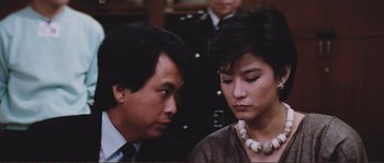 Movie still from “Police Story” (1985), directed by Jackie Chan – A man and a woman looking at one another; Close Up shot, High angle