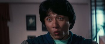 Movie still from “Police Story” (1985), directed by Jackie Chan – A person with his mouth wide open; Close Up shot, Low angle