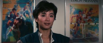 Movie still from “Police Story” (1985), directed by Jackie Chan – A person with short hair; Close Up shot, Low angle