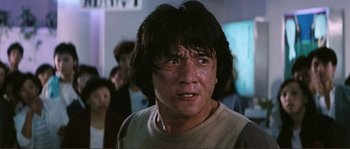 Movie still from “Police Story” (1985), directed by Jackie Chan – A person with long black hair; Close Up shot, Low angle