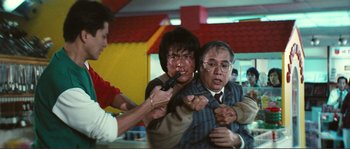 Movie still from “Police Story” (1985), directed by Jackie Chan – A group of people fighting with each other in front of a brick wall; Medium shot, Low angle