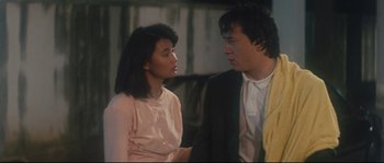 Movie still from “Police Story 2” (1988), directed by Jackie Chan – A man and a woman talking to each other; Medium shot, Over the shoulder angle