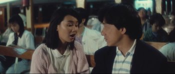 Movie still from “Police Story 2” (1988), directed by Jackie Chan – A woman and a man are talking to each other; Close Up shot, Over the shoulder angle