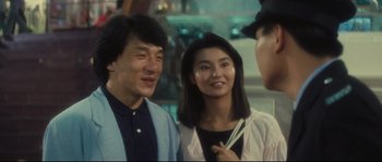 Movie still from “Police Story 2” (1988), directed by Jackie Chan – A man and a woman are standing next to each other; Close Up shot, Over the shoulder angle