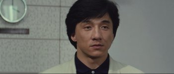 Movie still from “Police Story 2” (1988), directed by Jackie Chan – A person wearing a jacket; Close Up shot, Low angle