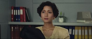 Movie still from “Police Story 2” (1988), directed by Jackie Chan – A person wearing a yellow shirt; Close Up shot, High angle