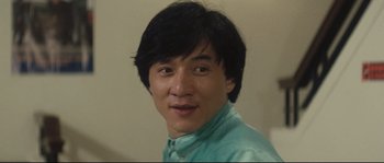 Movie still from “Police Story 2” (1988), directed by Jackie Chan – A person wearing a blue shirt; Close Up shot, Low angle