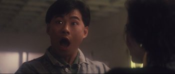 Movie still from “Police Story 2” (1988), directed by Jackie Chan – A man with his mouth wide open looking surprised; Close Up shot, Low angle
