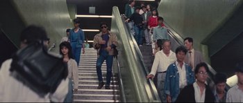 Movie still from “Police Story 2” (1988), directed by Jackie Chan – A group of people that are standing on some stairs; Wide shot, High angle