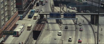 Movie still from “Police Story 2” (1988), directed by Jackie Chan – An aerial view of a busy city street with cars; Extreme Wide shot, High angle