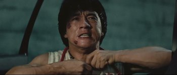 Movie still from “Police Story 2” (1988), directed by Jackie Chan – A man with blood all over his face and neck; Close Up shot, Low angle
