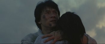 Movie still from “Police Story 2” (1988), directed by Jackie Chan – A man and a woman hugging in the dark; Close Up shot, Low angle