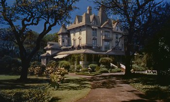 Movie still from “Pollyanna” (1960), directed by David Swift – A large white house sitting on top of a hill; Extreme Wide shot, Low angle