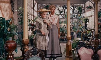 Movie still from “Pollyanna” (1960), directed by David Swift – Two women standing next to each other in a room; Medium shot, Low angle