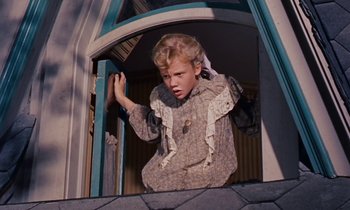 Movie still from “Pollyanna” (1960), directed by David Swift – A young girl is standing in a window sill; Medium shot, Low angle