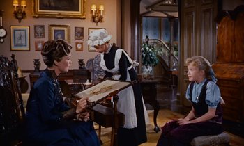 Movie still from “Pollyanna” (1960), directed by David Swift – Two women and a boy in a living room; Medium shot, High angle