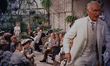 Movie still from “Pollyanna” (1960), directed by David Swift – A group of people sitting in chairs in a room; Wide shot, High angle