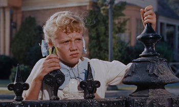 Movie still from “Pollyanna” (1960), directed by David Swift – A young girl holding a banana in her hand; Close Up shot, Low angle