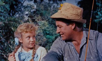 Movie still from “Pollyanna” (1960), directed by David Swift – A man and a little girl are talking to each other; Close Up shot, Low angle