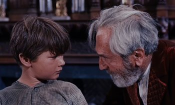 Movie still from “Pollyanna” (1960), directed by David Swift – An older man and a young boy looking at each other; Close Up shot, Over the shoulder angle