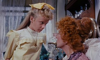 Movie still from “Pollyanna” (1960), directed by David Swift – A woman and a little girl are talking to each other; Close Up shot, Over the shoulder angle