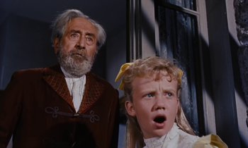 Movie still from “Pollyanna” (1960), directed by David Swift – An old man and a young girl looking surprised; Close Up shot, Low angle