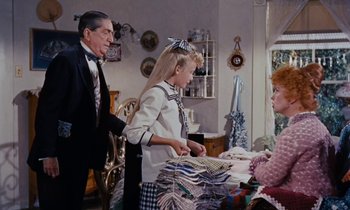 Movie still from “Pollyanna” (1960), directed by David Swift – A man and a woman and a little girl in a room; Medium shot, Over the shoulder angle