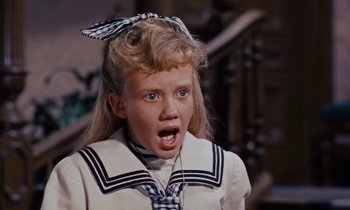 Movie still from “Pollyanna” (1960), directed by David Swift – A little girl wearing a sailor's outfit with her mouth wide open; Close Up shot, High angle