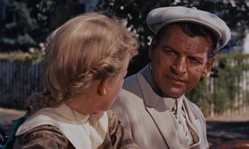 Movie still from “Pollyanna” (1960), directed by David Swift – An older man and a young girl are talking to each other; Close Up shot, Over the shoulder angle
