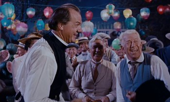 Movie still from “Pollyanna” (1960), directed by David Swift – A group of men standing next to each other in a room; Medium shot, Over the shoulder angle
