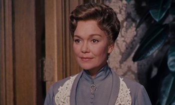 Movie still from “Pollyanna” (1960), directed by David Swift – An older woman in a blue dress and a white lace collar; Close Up shot, Over the shoulder angle