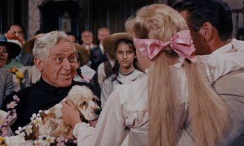 Movie still from “Pollyanna” (1960), directed by David Swift – An old man and a woman with a small dog; Close Up shot, Over the shoulder angle