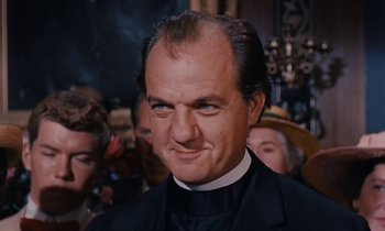 Movie still from “Pollyanna” (1960), directed by David Swift – A person wearing a suit and tie; Close Up shot, Low angle