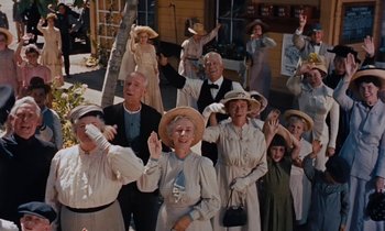 Movie still from “Pollyanna” (1960), directed by David Swift – A group of people dressed in old fashioned clothing; Wide shot, Low angle