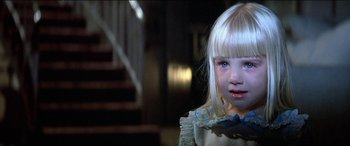 Movie still from “Poltergeist” (1982), directed by Tobe Hooper – A little girl with blonde hair and blue eyes; Close Up shot, High angle