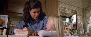Movie still from “Poltergeist” (1982), directed by Tobe Hooper – A woman and a little girl are sitting at a table; Close Up shot, Over the shoulder angle
