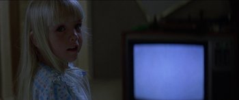 Movie still from “Poltergeist” (1982), directed by Tobe Hooper – A little girl standing in front of a television; Close Up shot, Over the shoulder angle