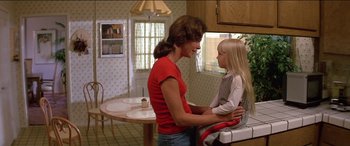 Movie still from “Poltergeist” (1982), directed by Tobe Hooper – A woman and a child in a kitchen; Medium shot, Over the shoulder angle